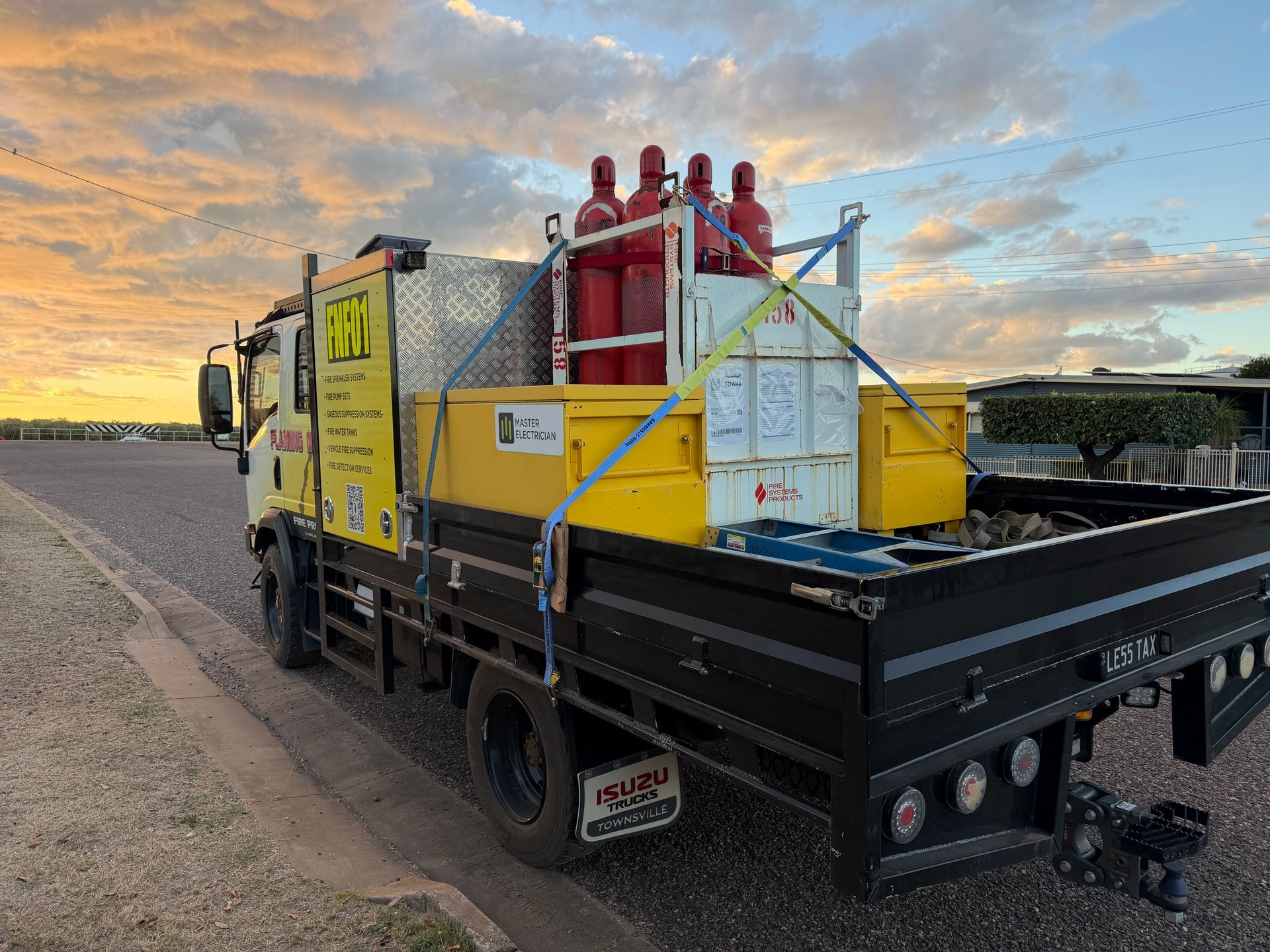 Yellow Utility Truck With Red Equipment on the Back, Parked Roadside at Sunset — Flaming North Fire Protection Pty Ltd in Garbutt, QLD