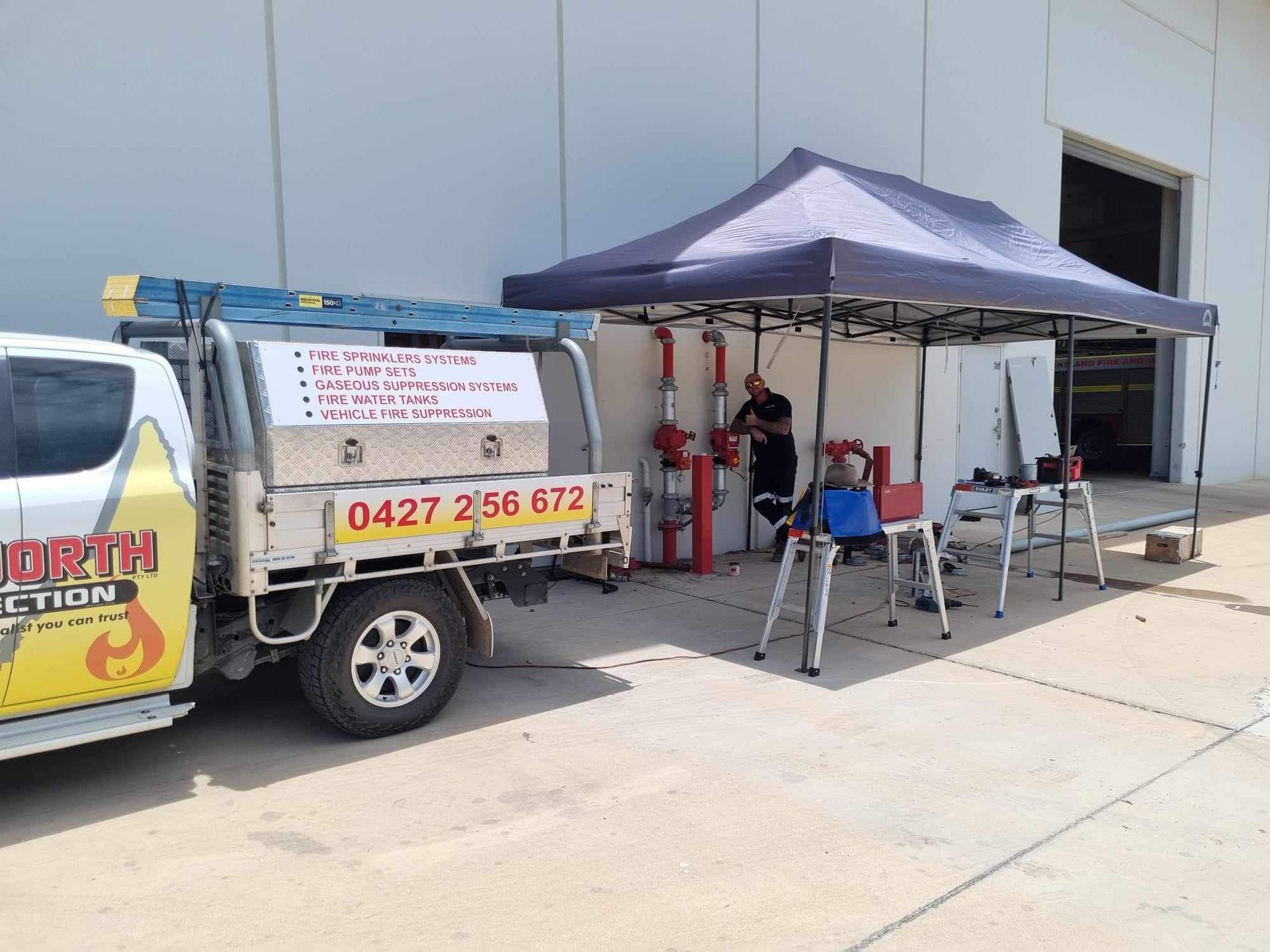 Food Truck Parked Outside a Building With a Grey Canopy and Chairs Set Up Beside It — Flaming North Fire Protection Pty Ltd in Garbutt, QLD