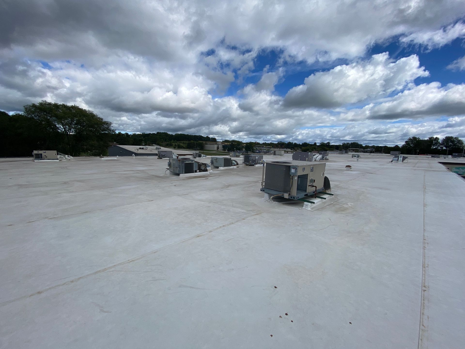 A roof that is being built with a satellite dish in the background