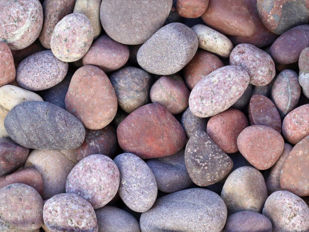 Sino Red Natural Pebbles 20kg Bags — Tweed Landscape Supplies in Tweed Heads, NSW