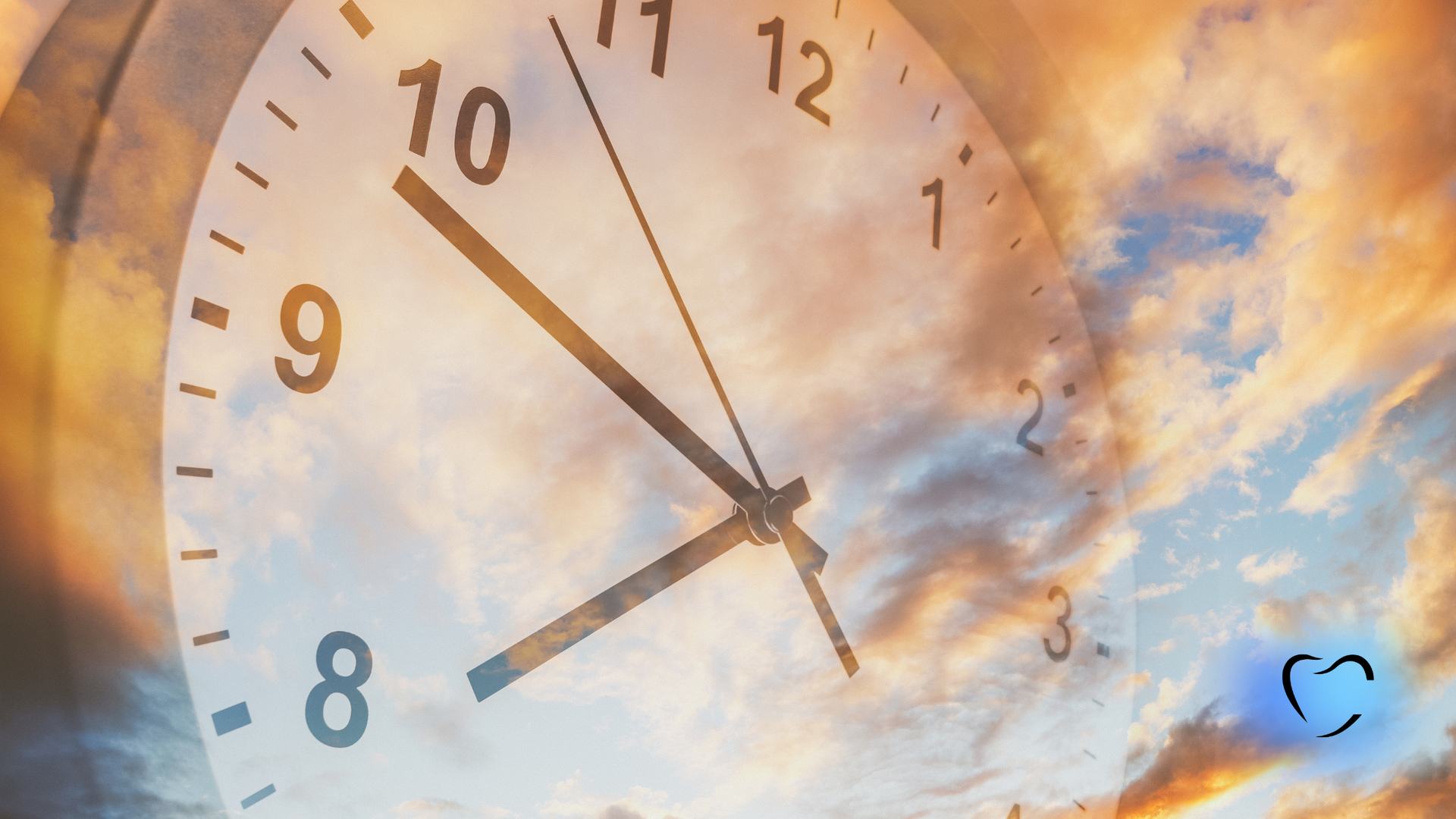 An analog clock face overlaid on a cloudy, golden sunset sky.