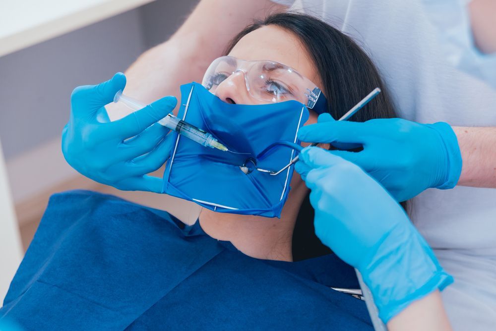 An illustration of a tooth being drilled with a dental tool.