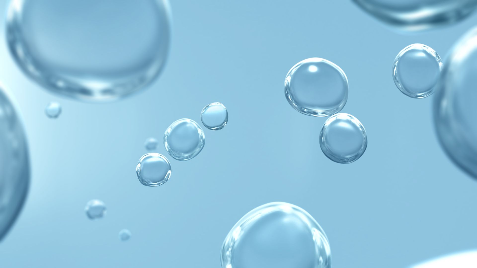 Transparent, floating bubbles on a light blue background.