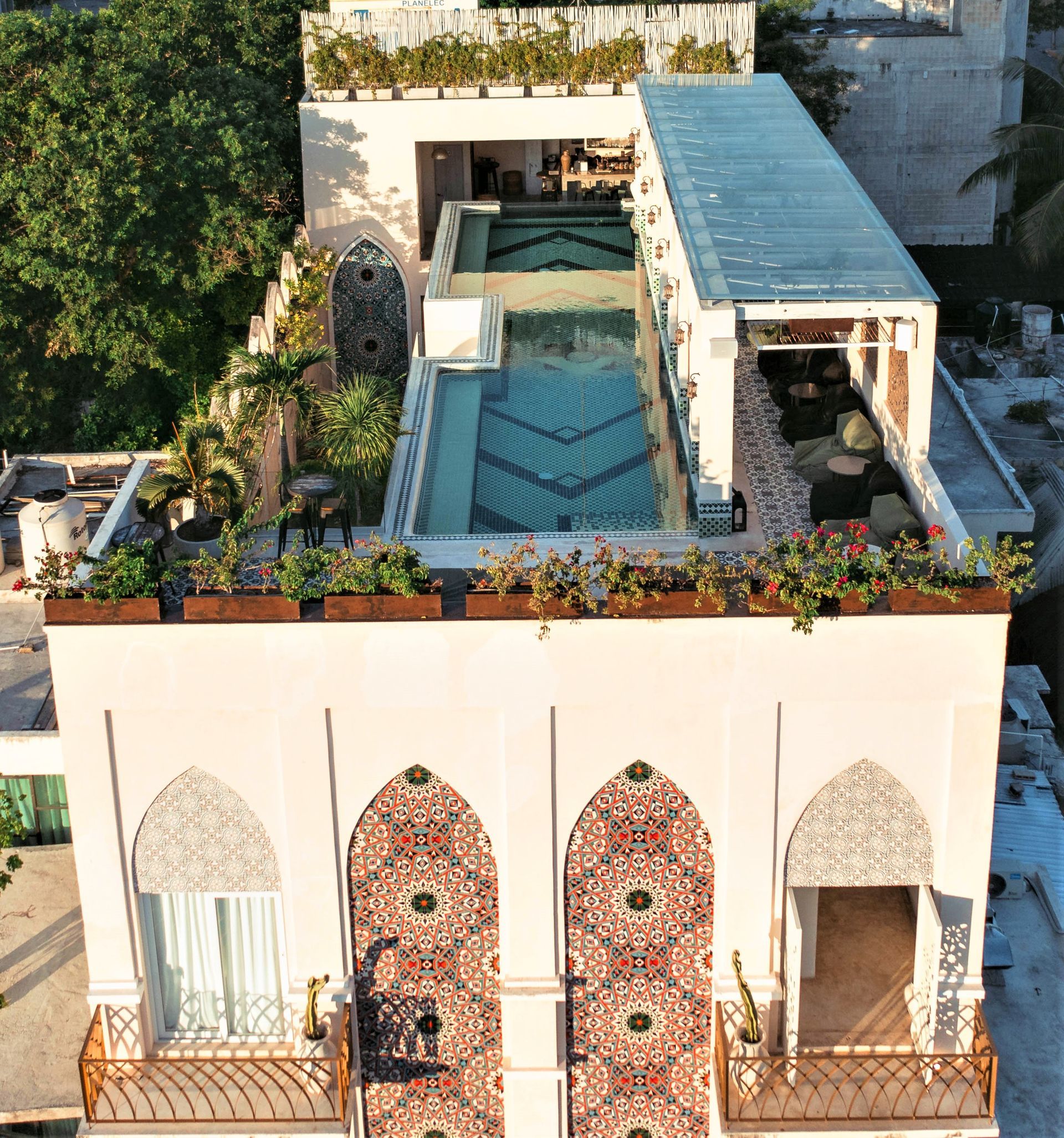 An aerial view of a building with a swimming pool on top