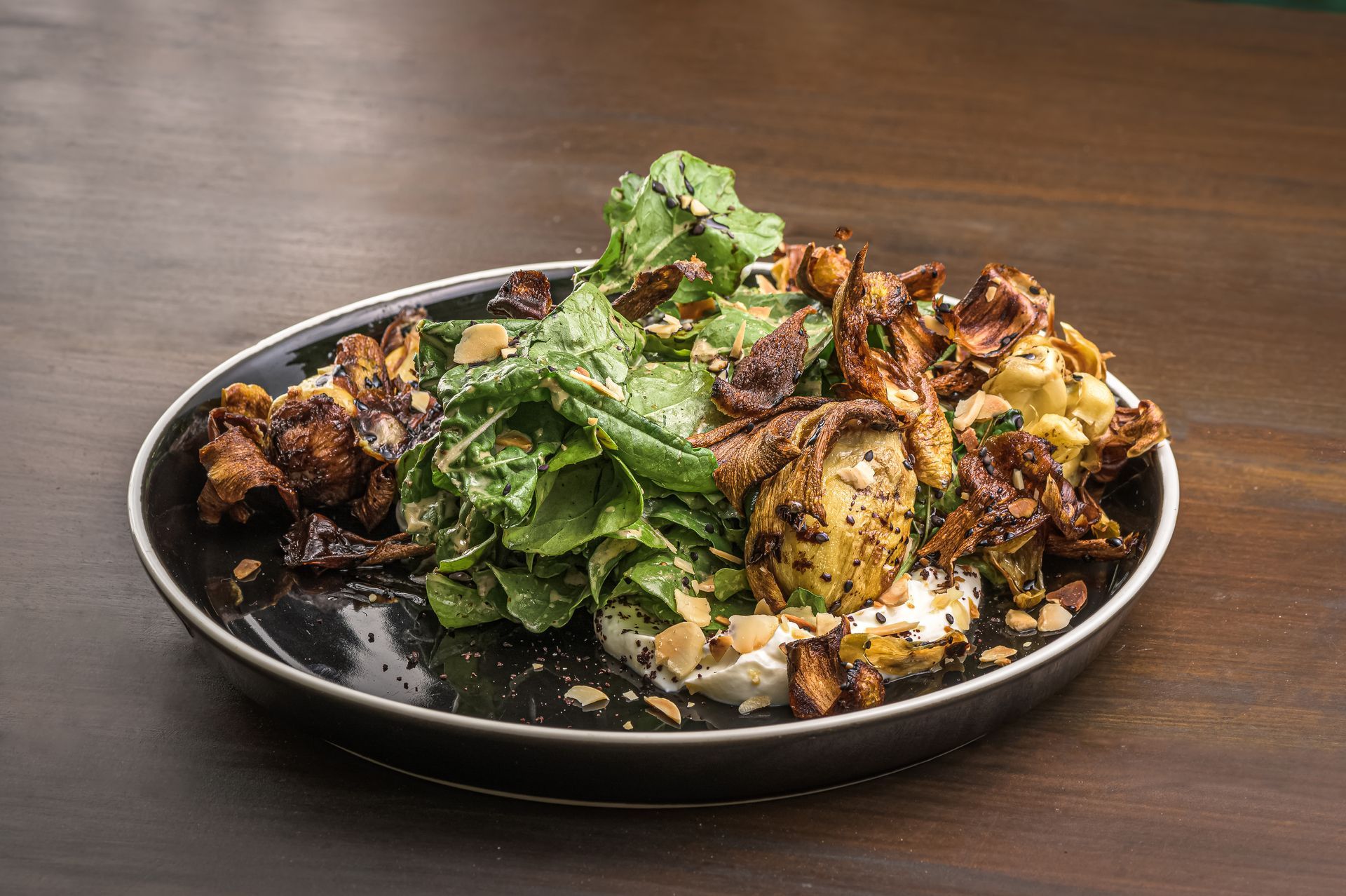 A plate of food is sitting on a wooden table.
