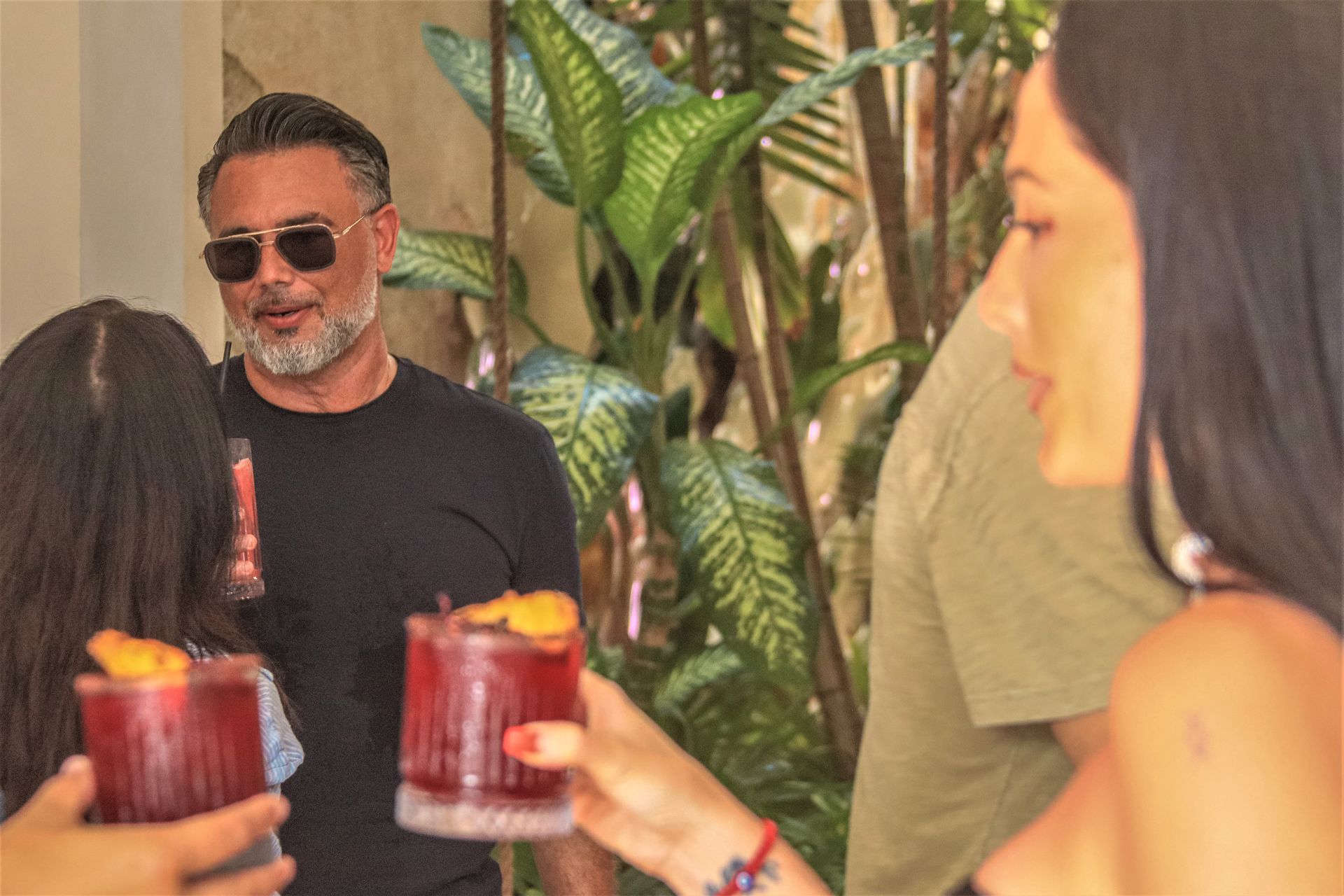 A group of people are toasting with drinks at a party.