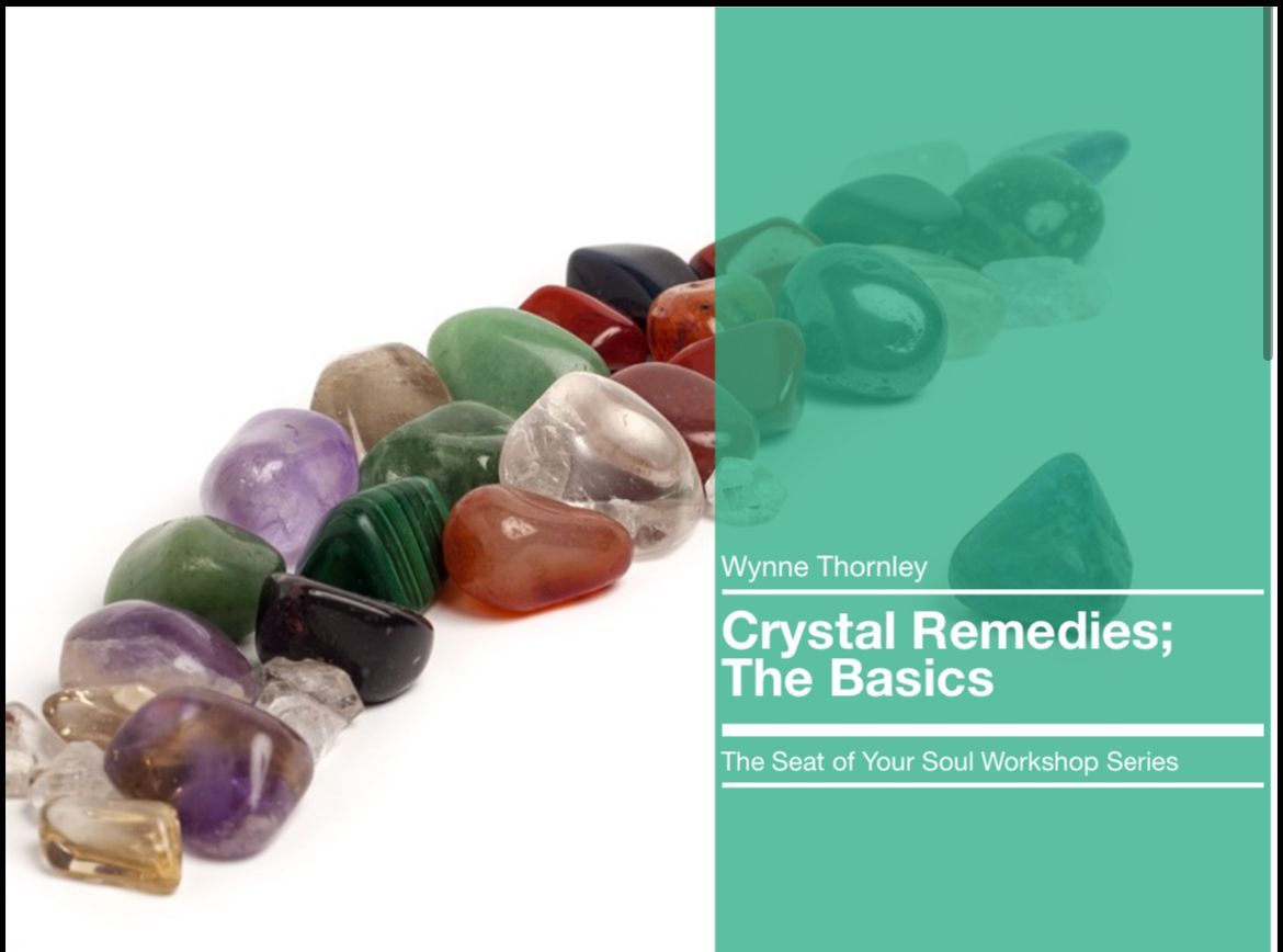 Close-up of colorful crystals arranged on a white background, with text: 