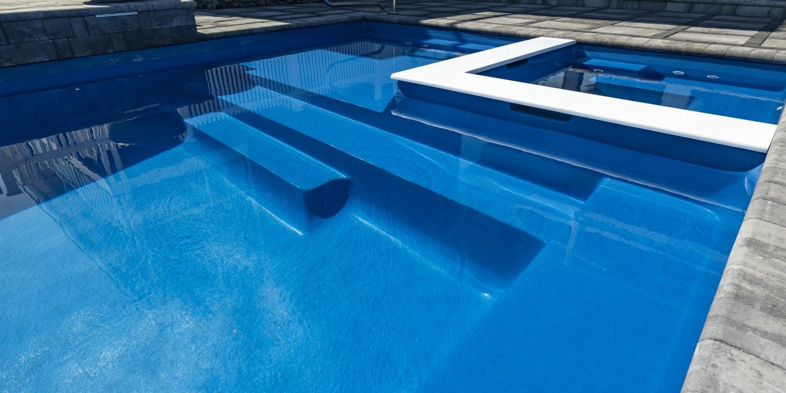 Close up of a fiberglass pool installed by Xscape 2 Nature in a Maryland backyard