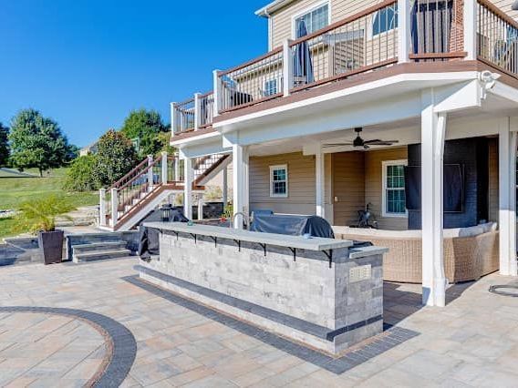 A large house with a patio area and a large deck.