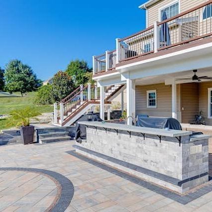 There is a large deck with stairs leading up to it.