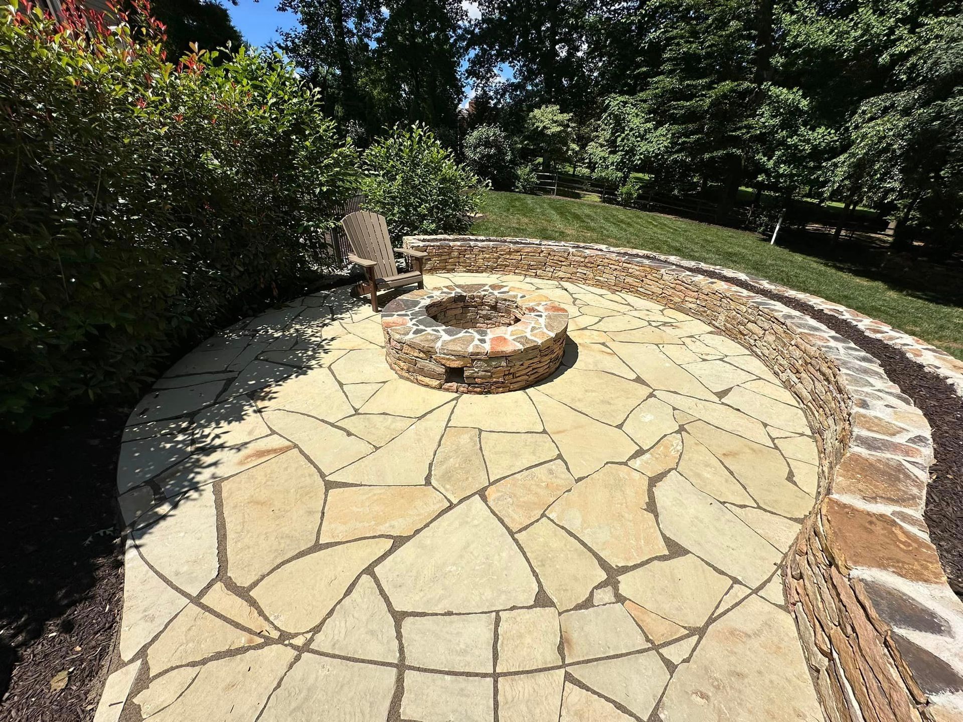Stone patio and fire pit installation by patio design company X2N