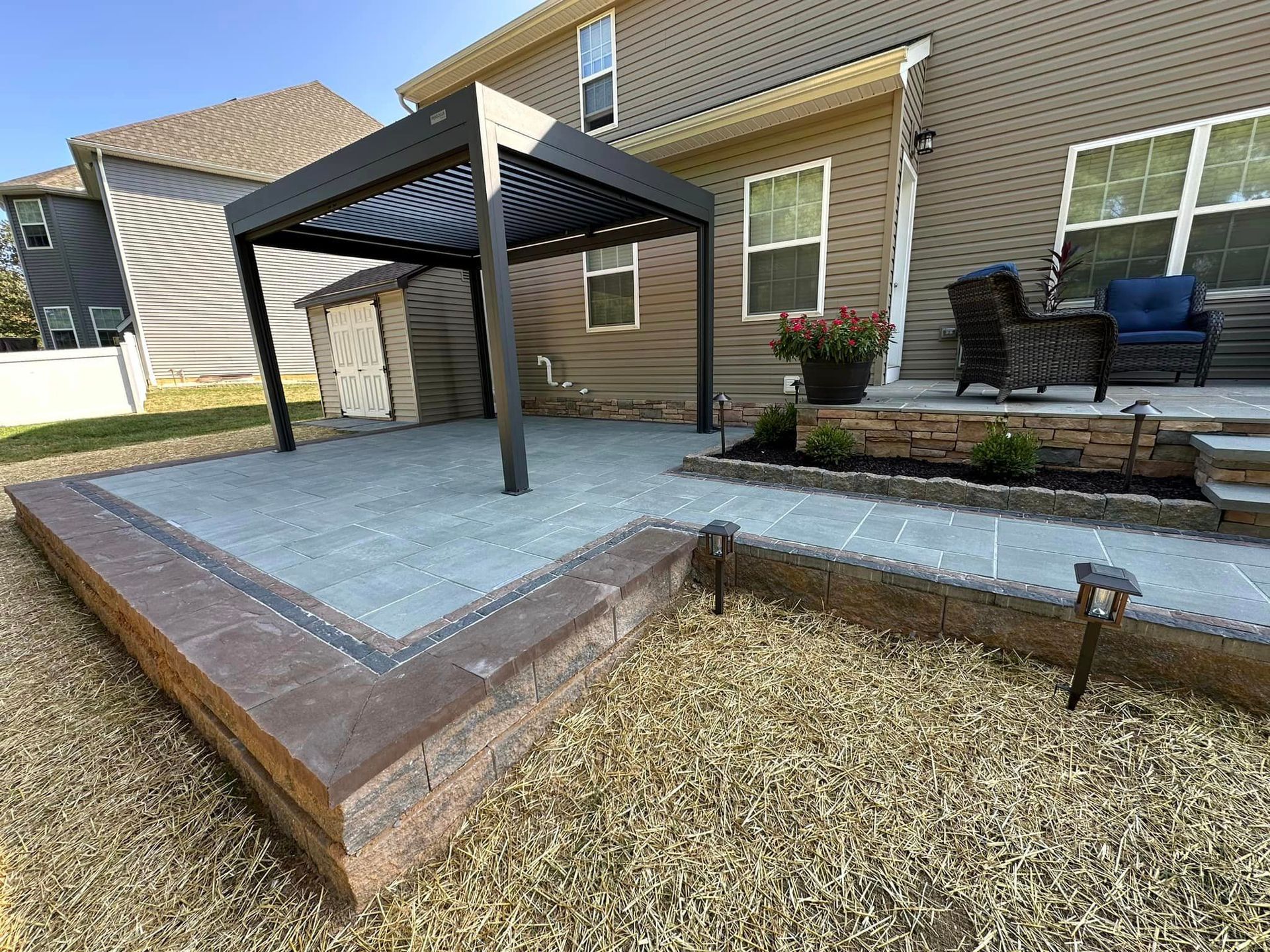 Newly installed multi-level patio with pergola showcasing expert hardscaping design by Xscape 2 Nature in Maryland.