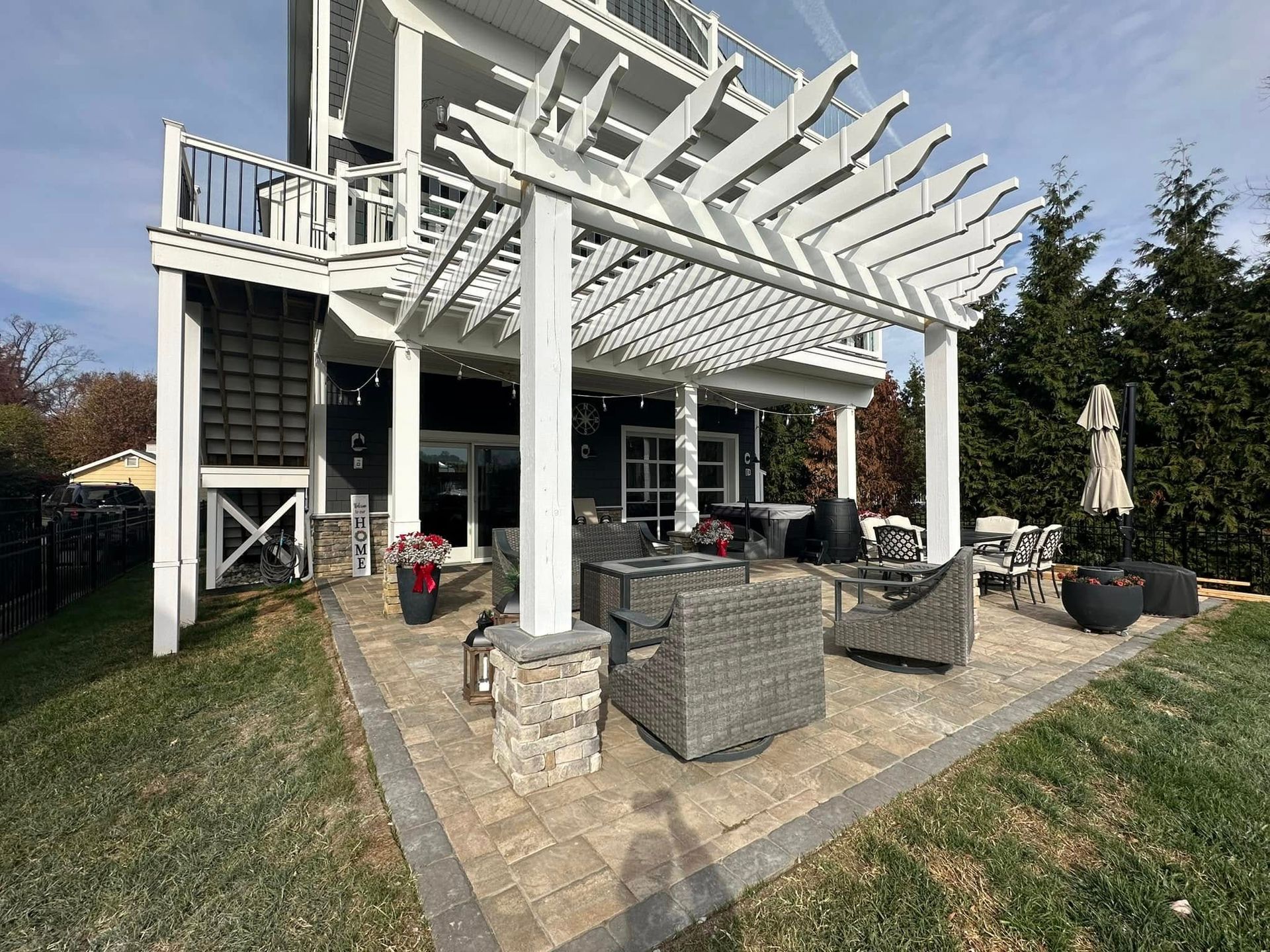 Outdoor living space featuring paver patio and pergola by expert patio builder