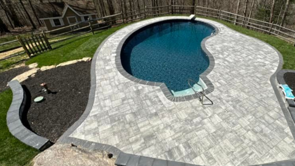 Custom fiberglass pool with a coordinated pool deck and outdoor living area at an Annapolis Maryland