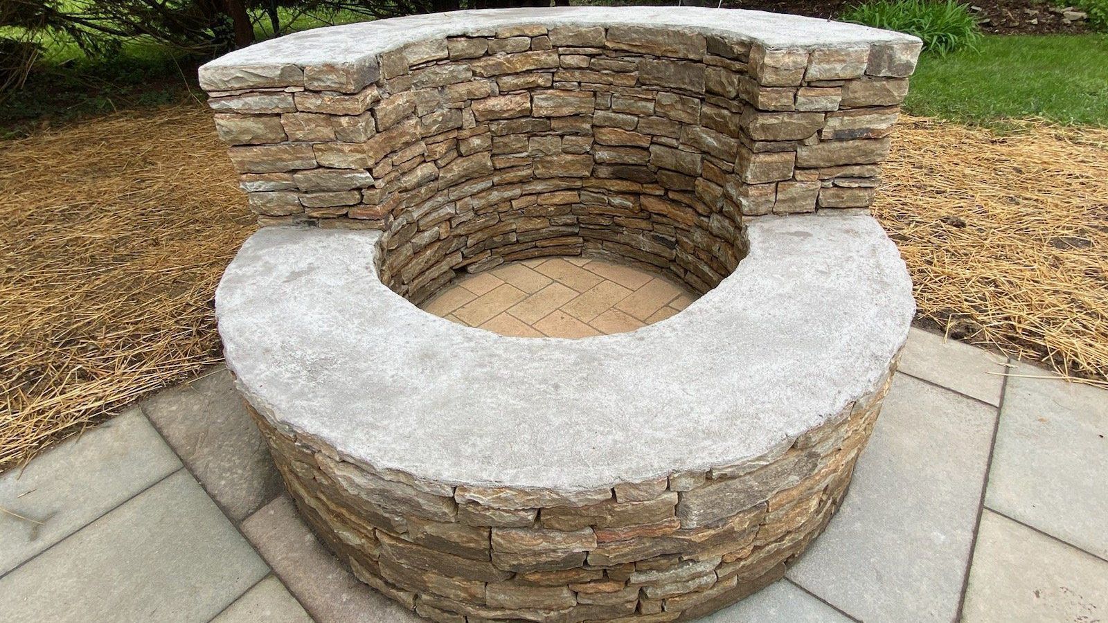 Natural stone fire pit on a stamped concrete patio in maryland