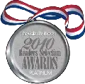A silver medal with a red , white and blue ribbon.