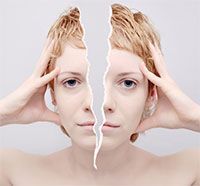 A woman 's face is split in half by a piece of paper.