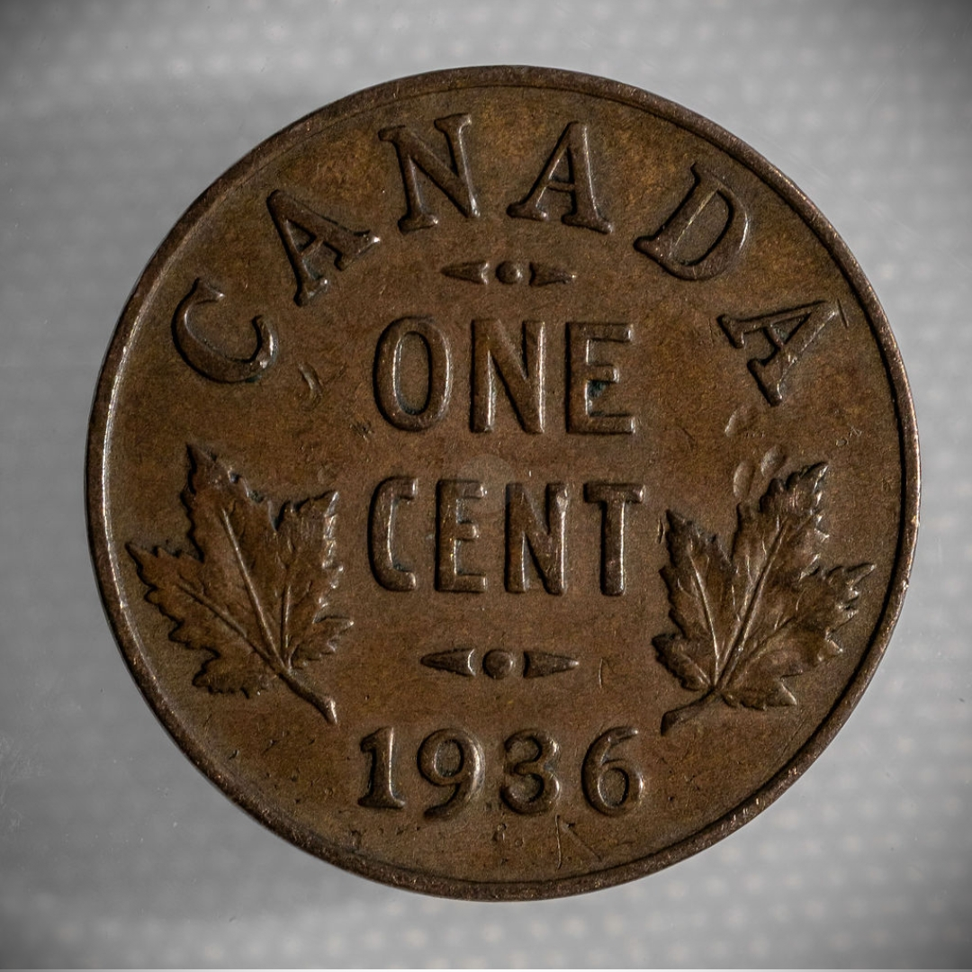 Canadian one-cent coin dated 1936, brown copper with maple leaves