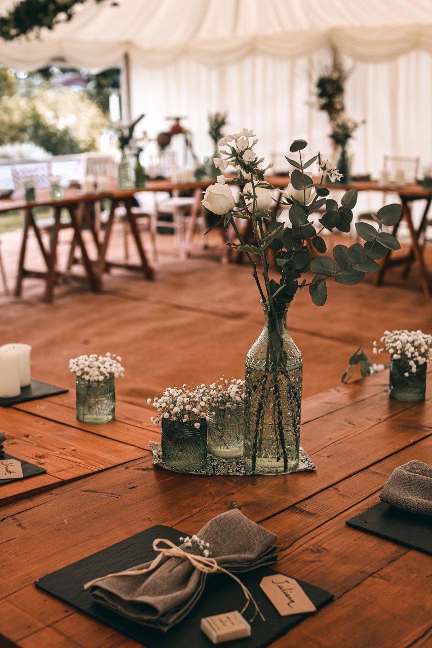 A wooden table with a vase of flowers on it.