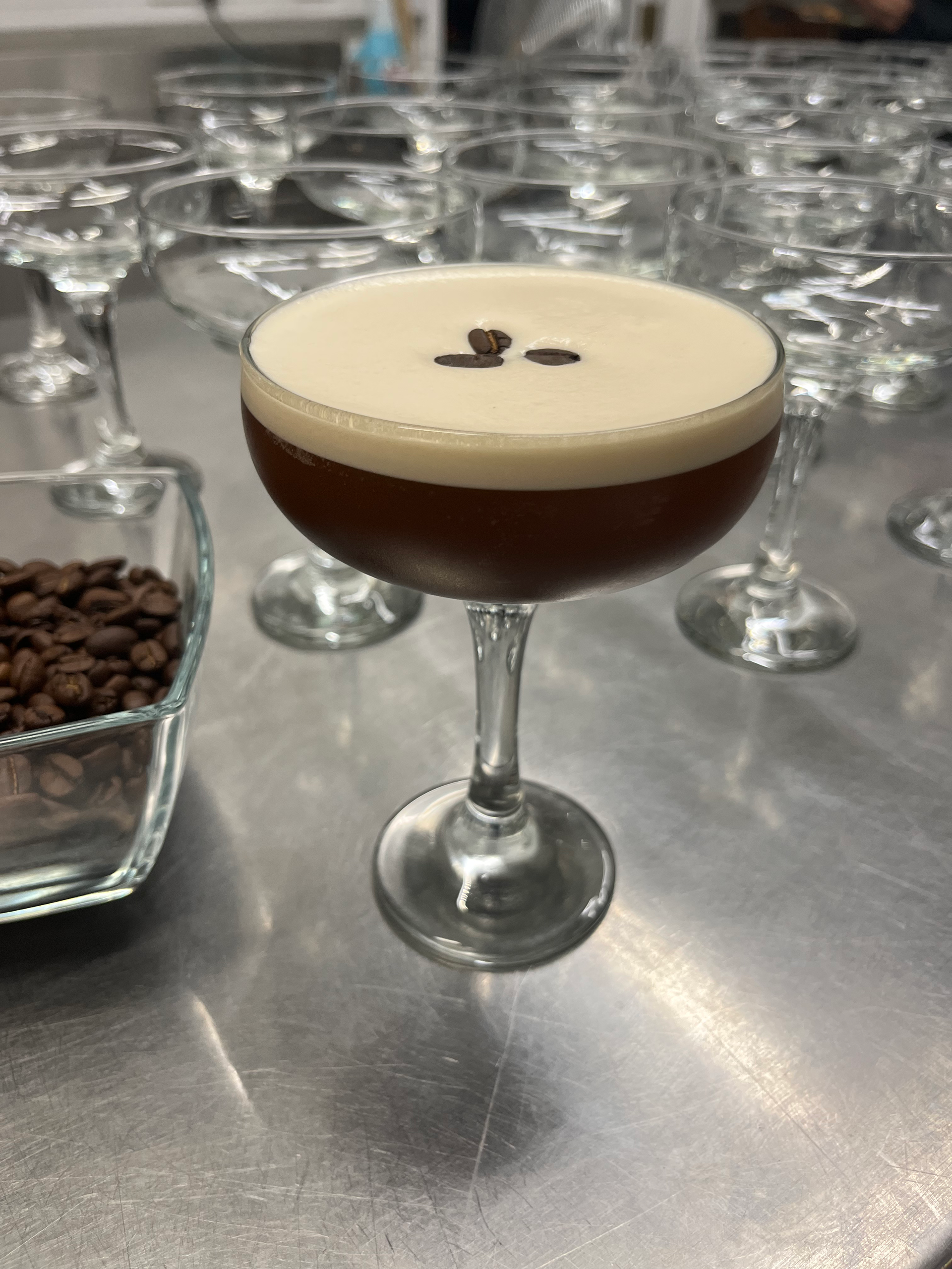 A close up of a martini in a glass on a table.