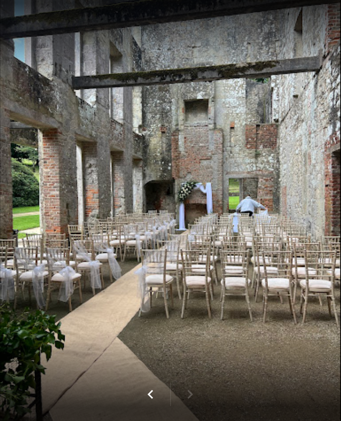 A row of chairs are lined up in an old building