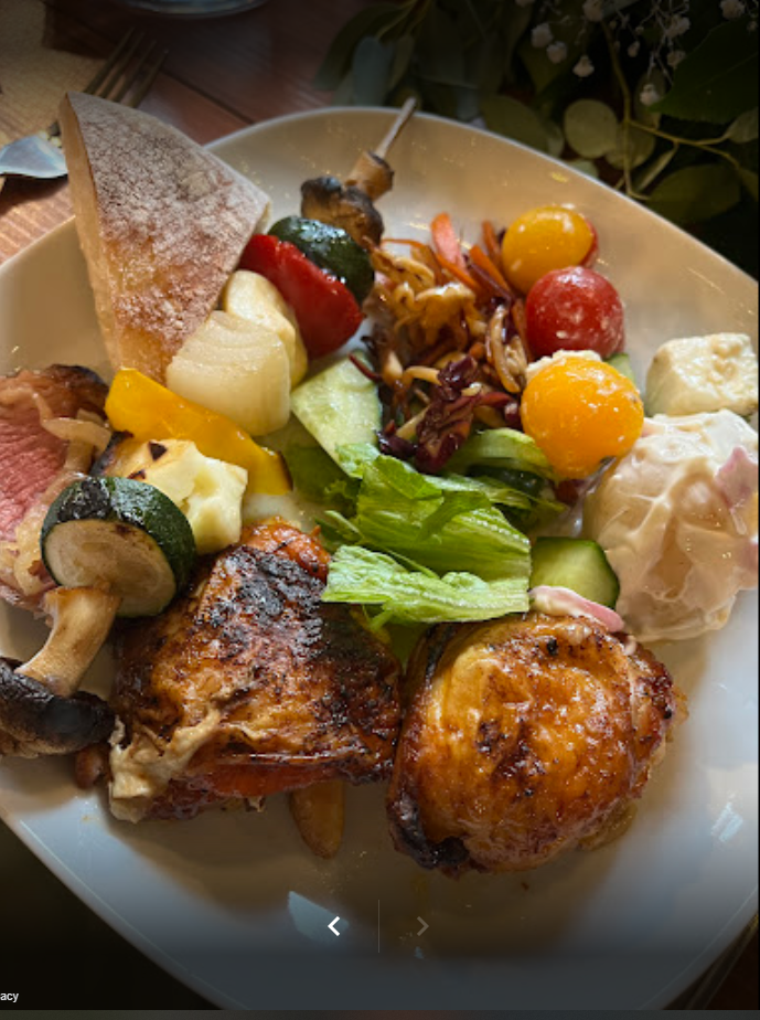 A plate of food with meat and vegetables on a table.