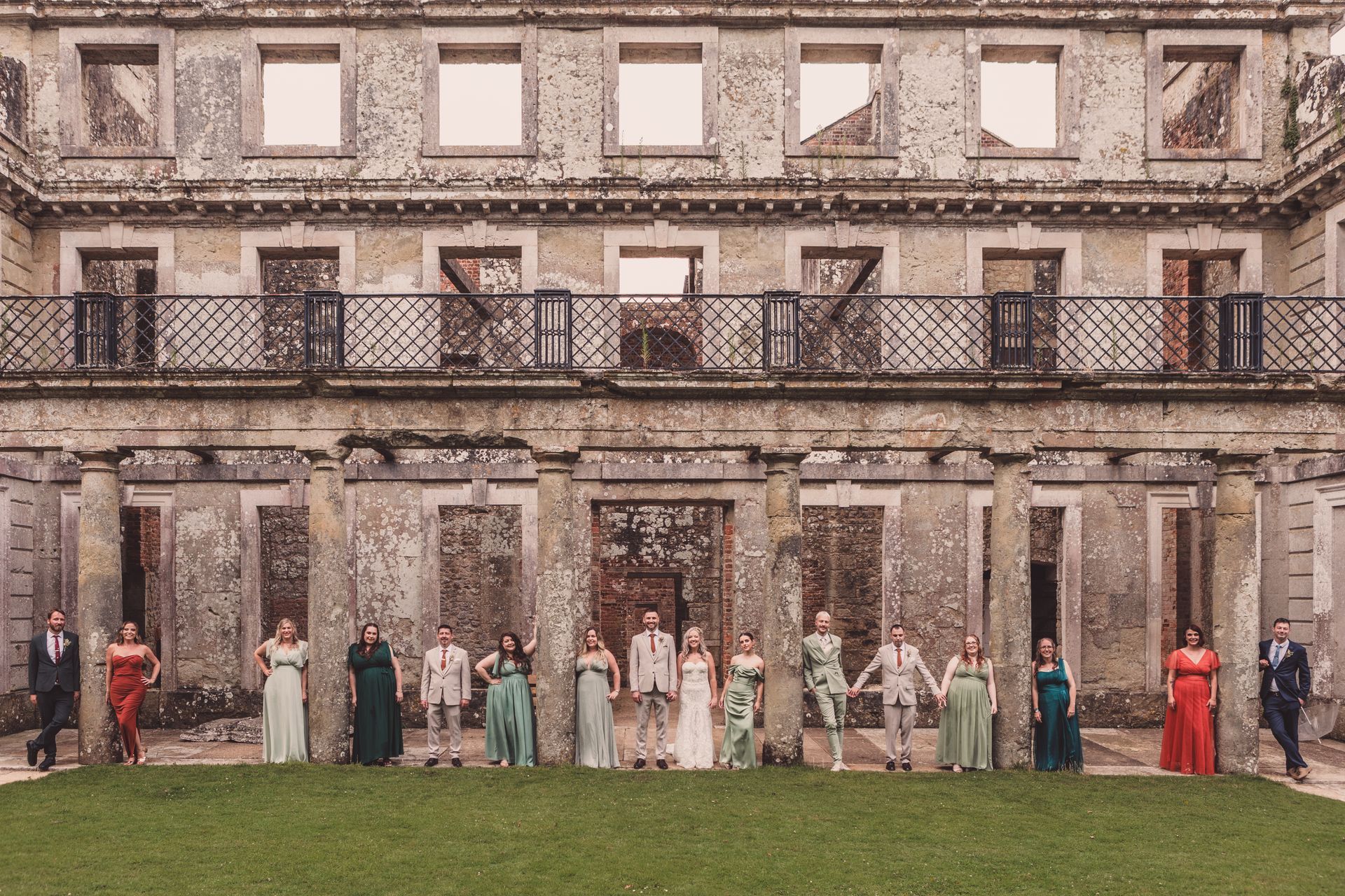 A group of people standing in front of a building holding hands