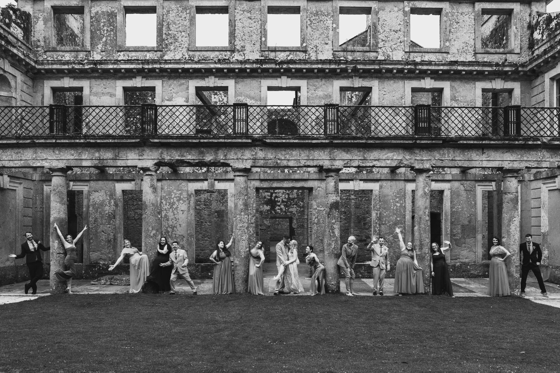 A black and white photo of a group of people standing in front of a building