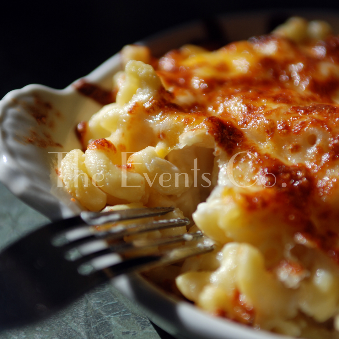 A bowl of macaroni and cheese with a fork in it and the words the events on the bottom