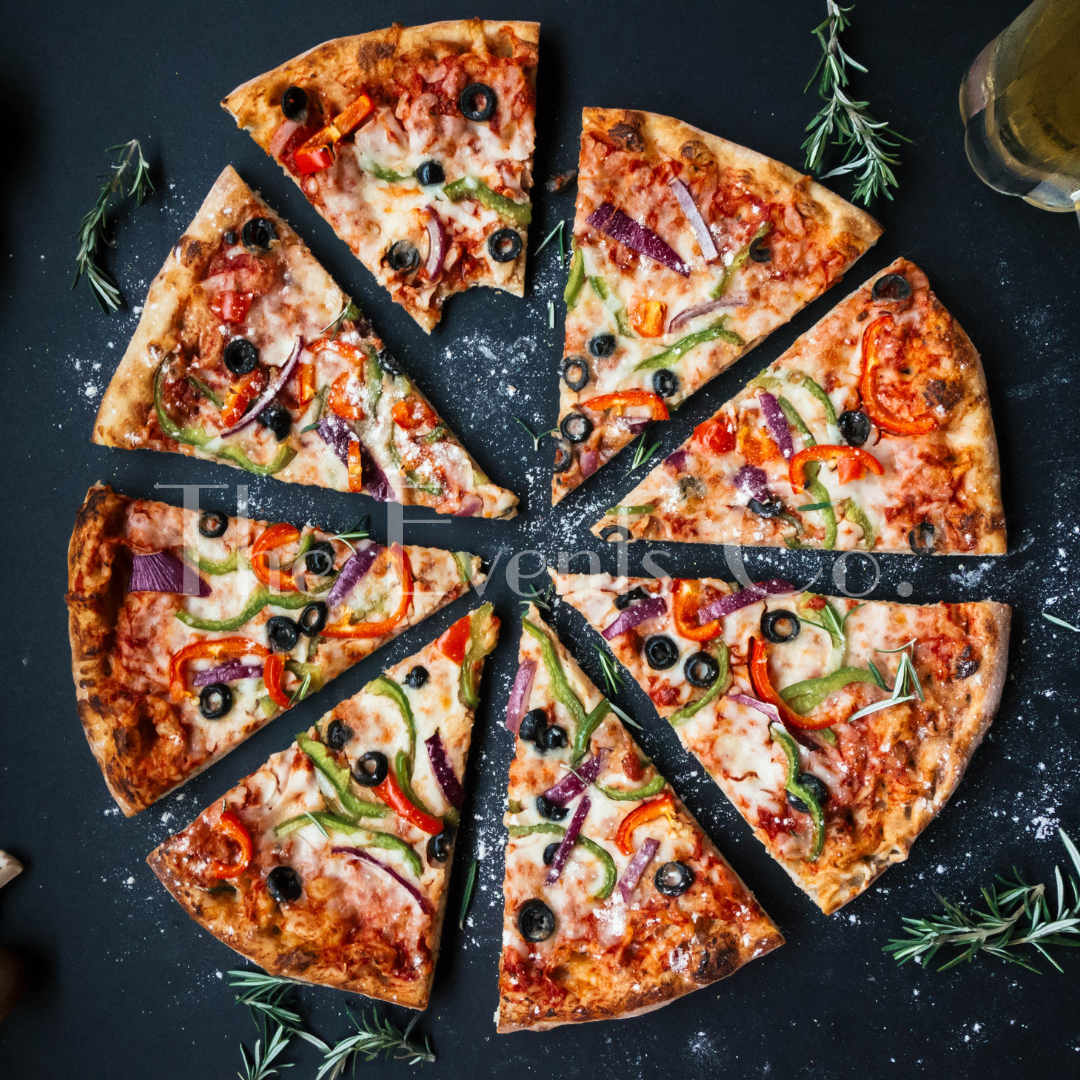 A pizza is cut into slices and sitting on a table