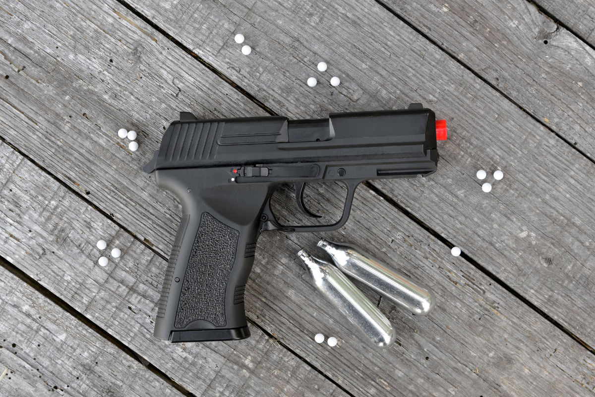 A black air gun and 2 bullets