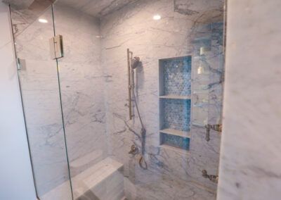 A bathroom with a walk in shower and a bathtub.