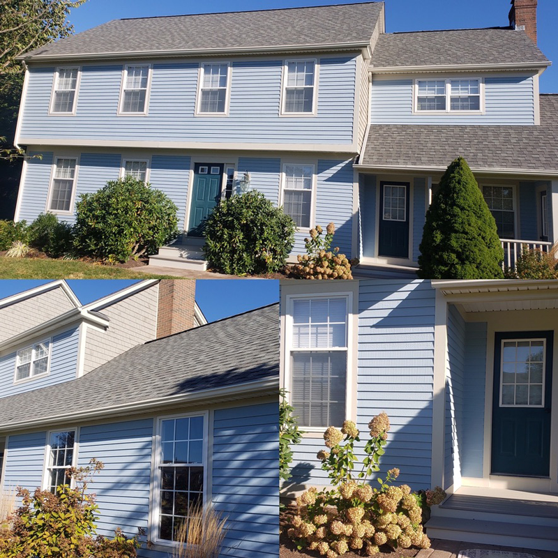 A blue house with a gray roof and a blue door