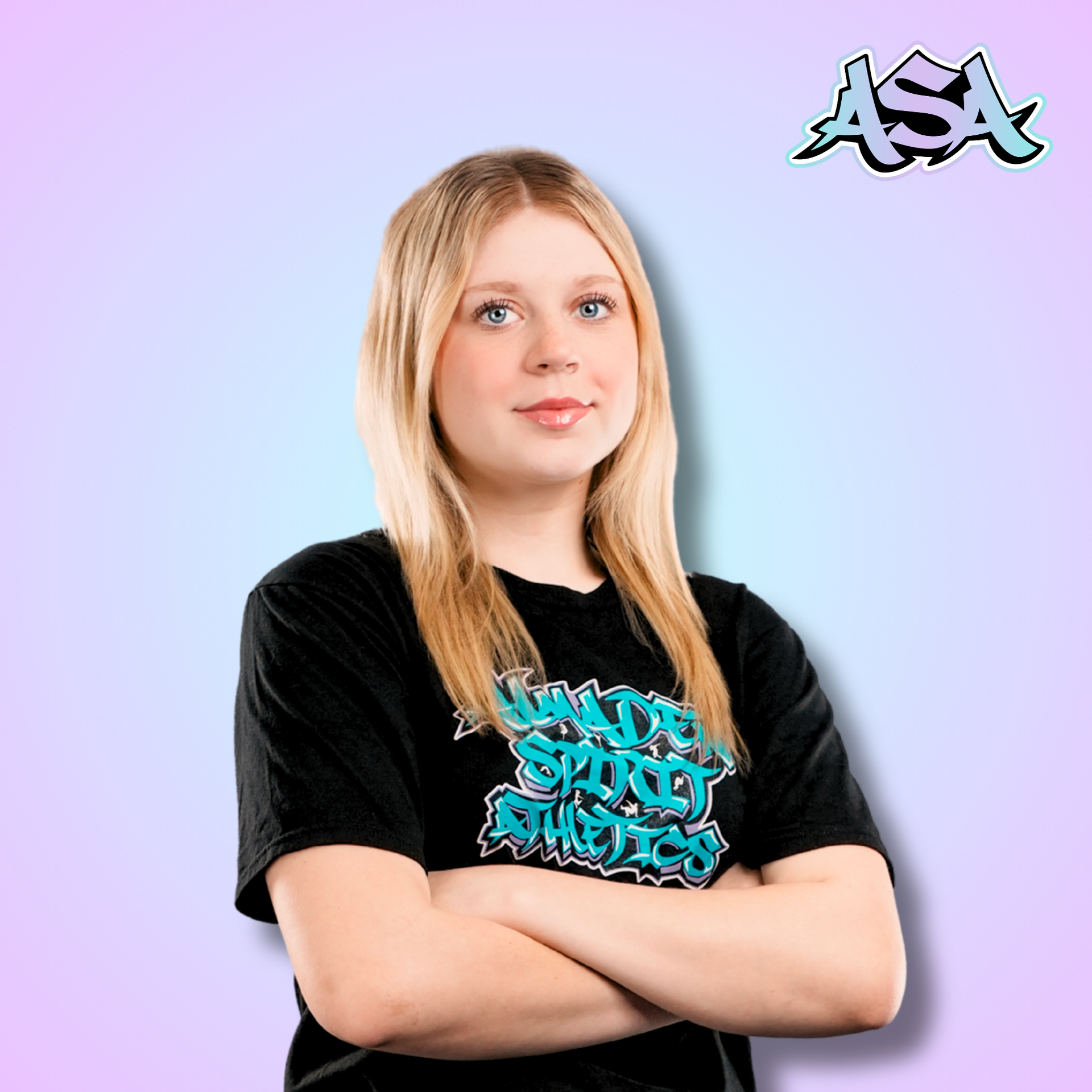 A woman wearing a black t-shirt with graffiti on it is smiling.