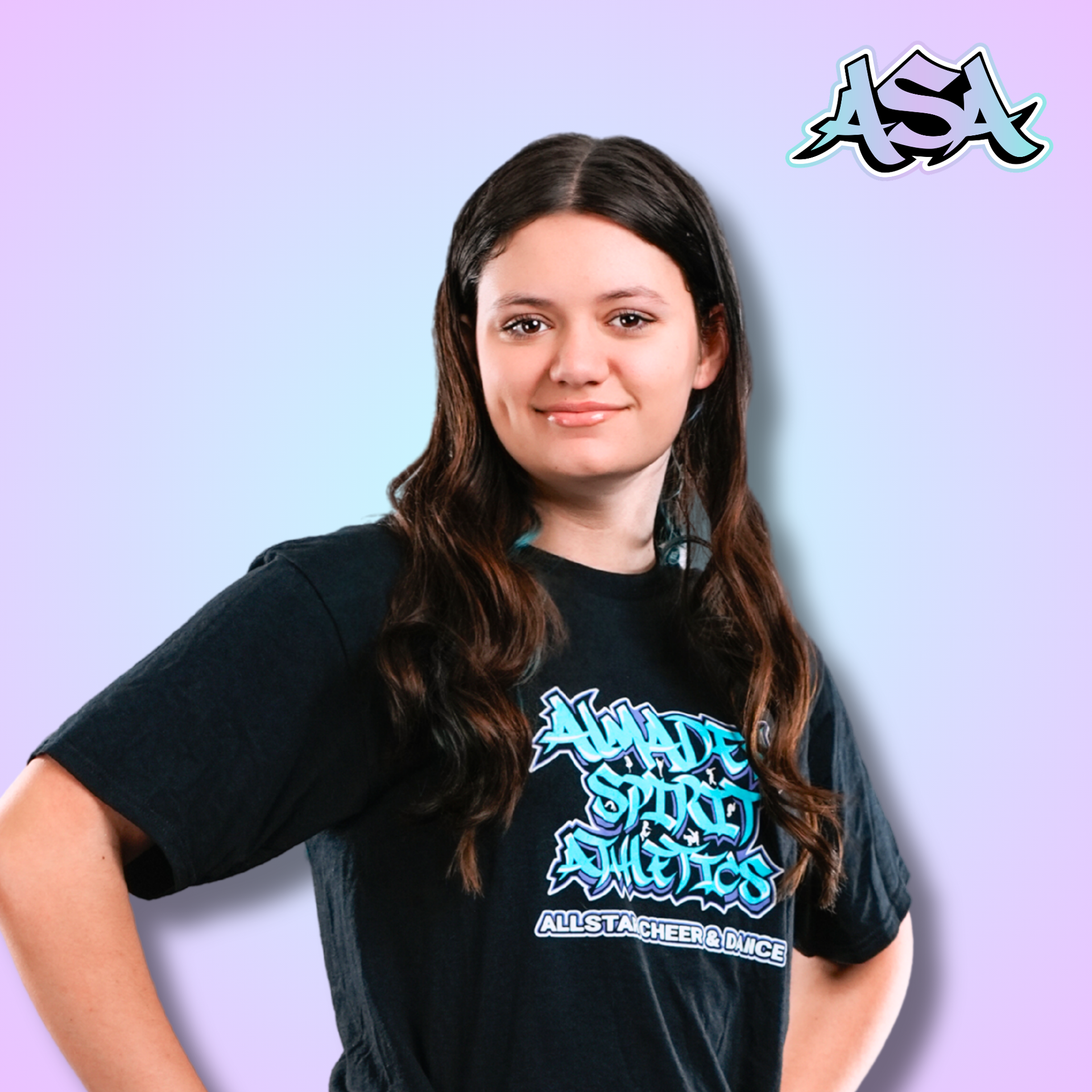 A woman wearing a black t-shirt with graffiti on it is smiling.