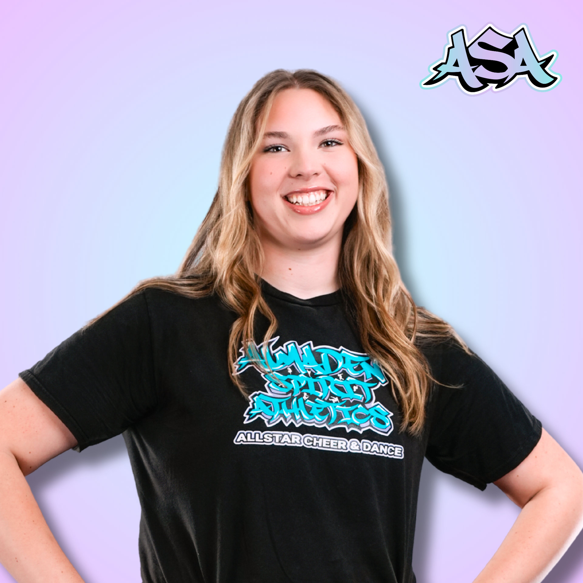 A woman wearing a black t-shirt with graffiti on it is smiling.