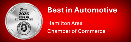 A silver coin that says best in automotive hamilton area chamber of commerce
