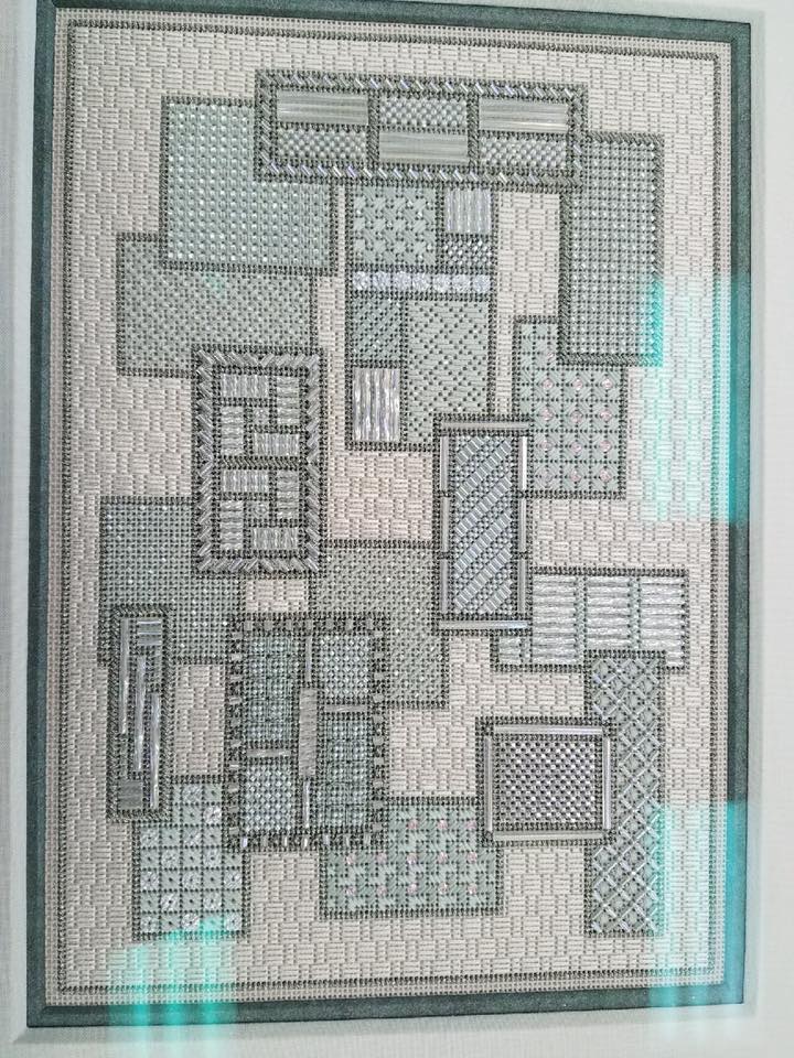 A framed drawing featuring a collage of overlapping rectangular shapes, each filled with different monochrome patterns.