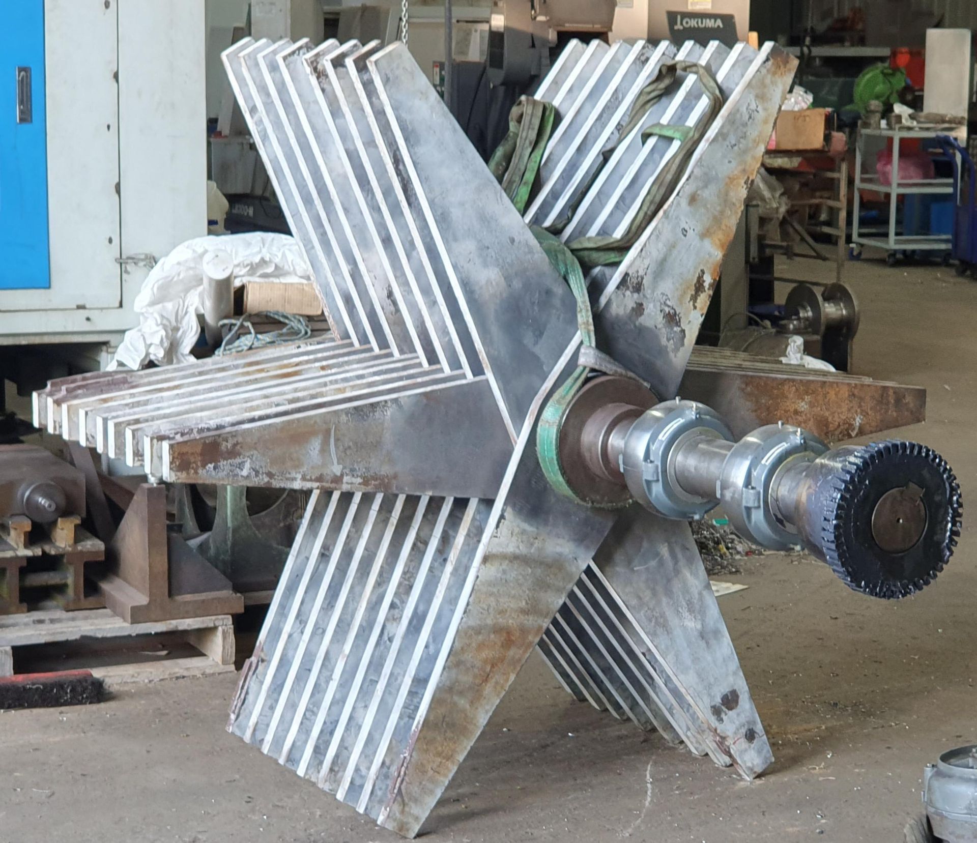 A large piece of metal is sitting on the ground in a room