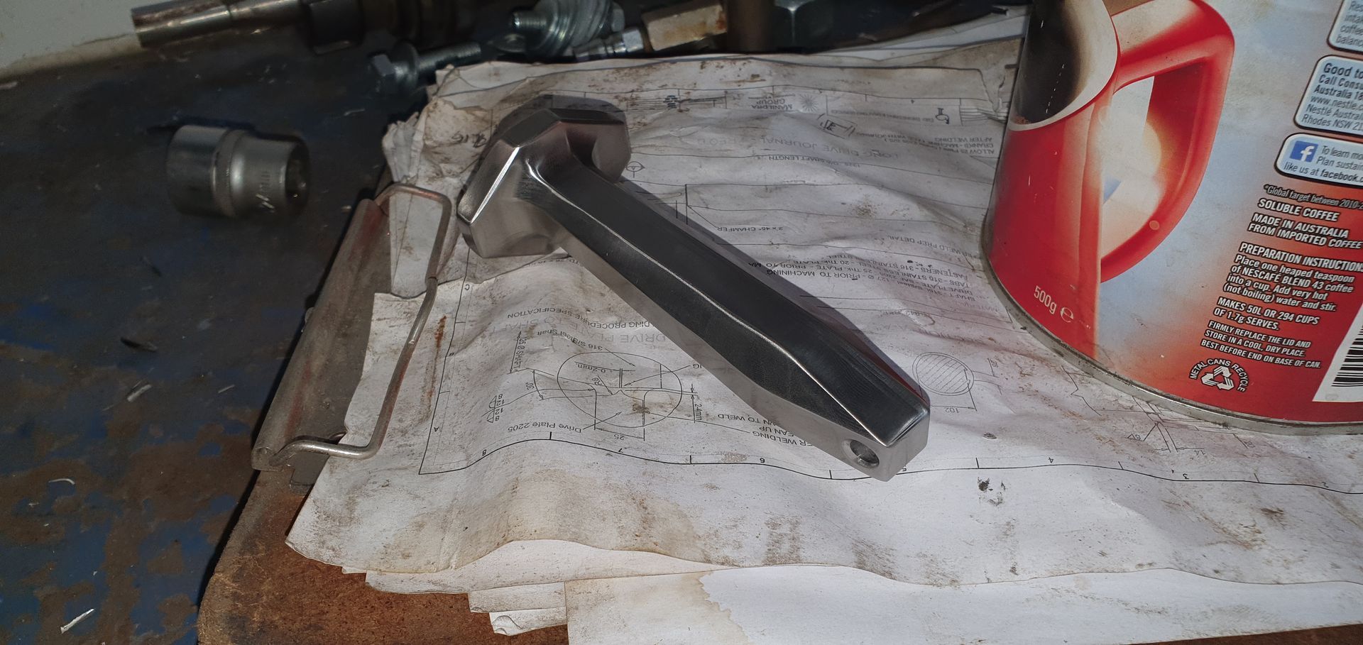 A hammer is sitting on a towel next to a can of coca cola