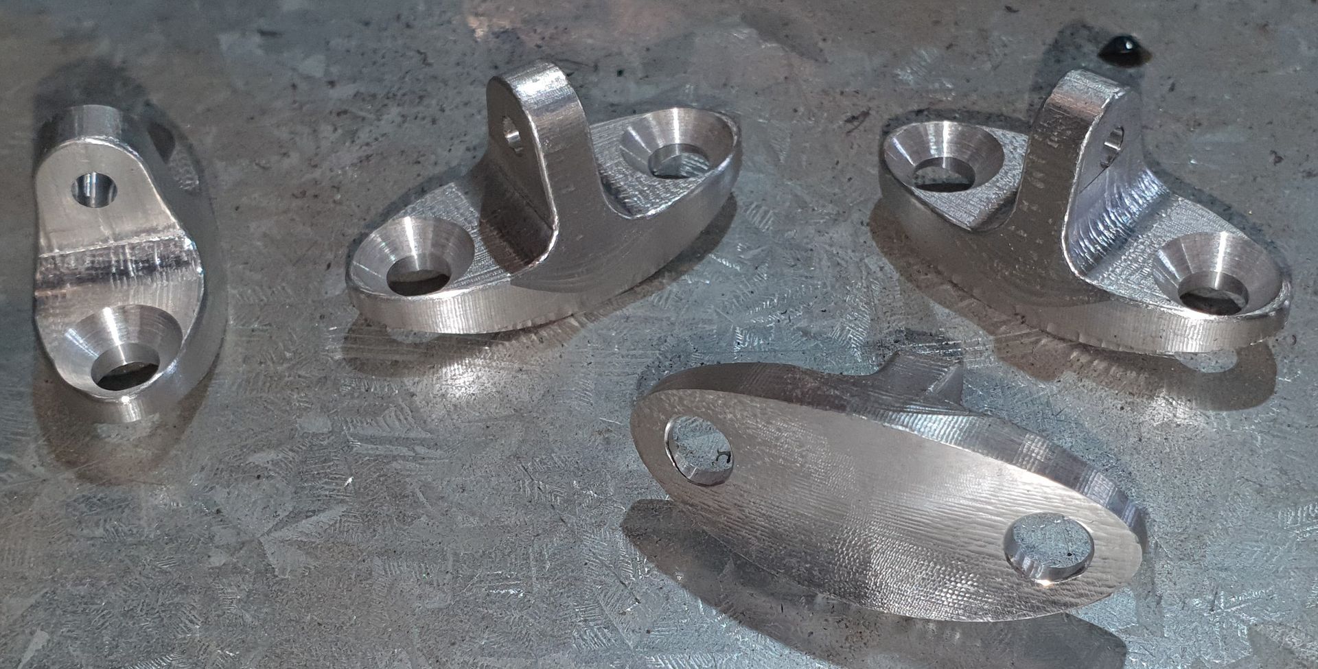 A group of metal pieces sitting on top of a metal surface.