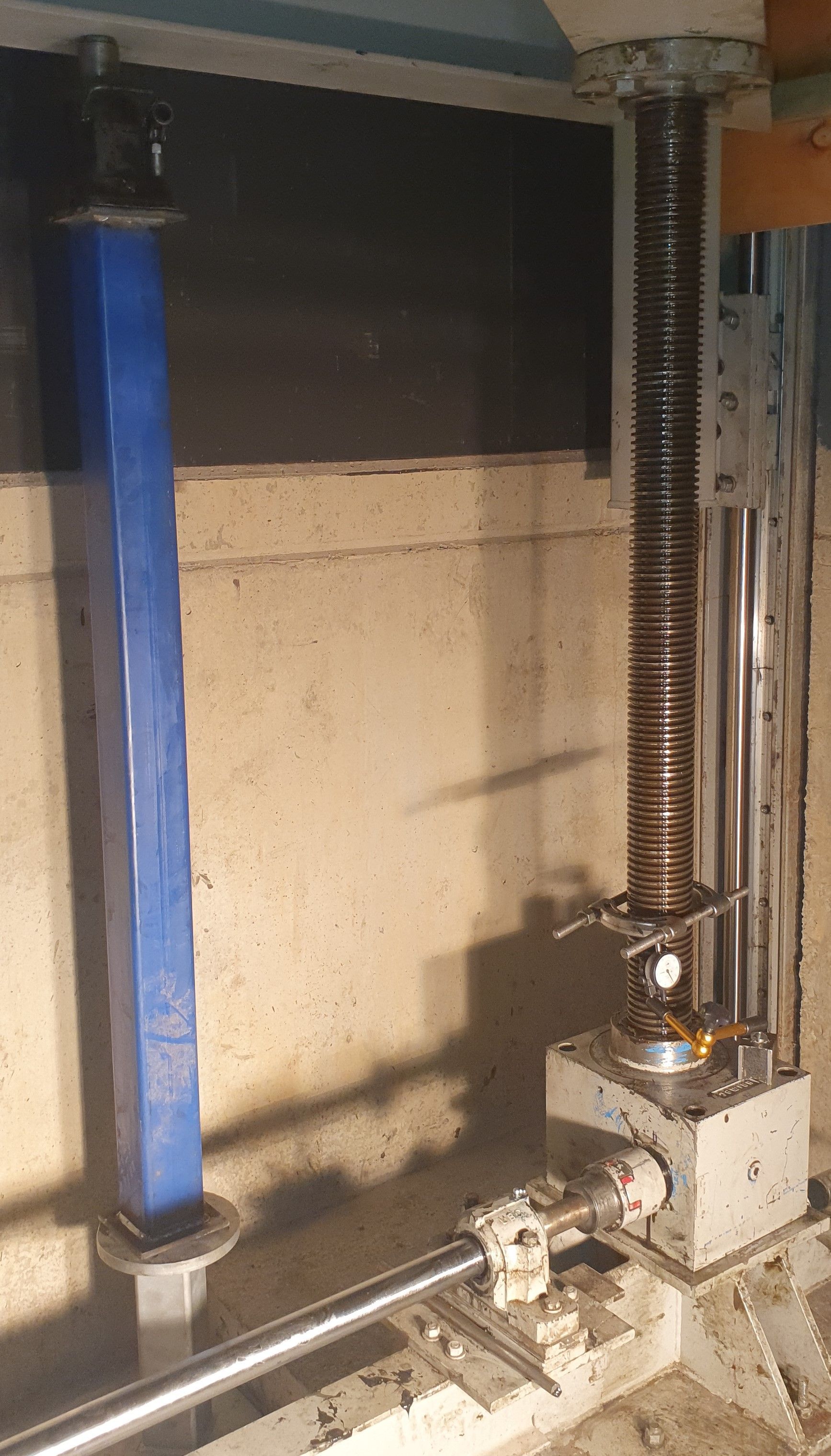 A machine is sitting in a room next to a wall.