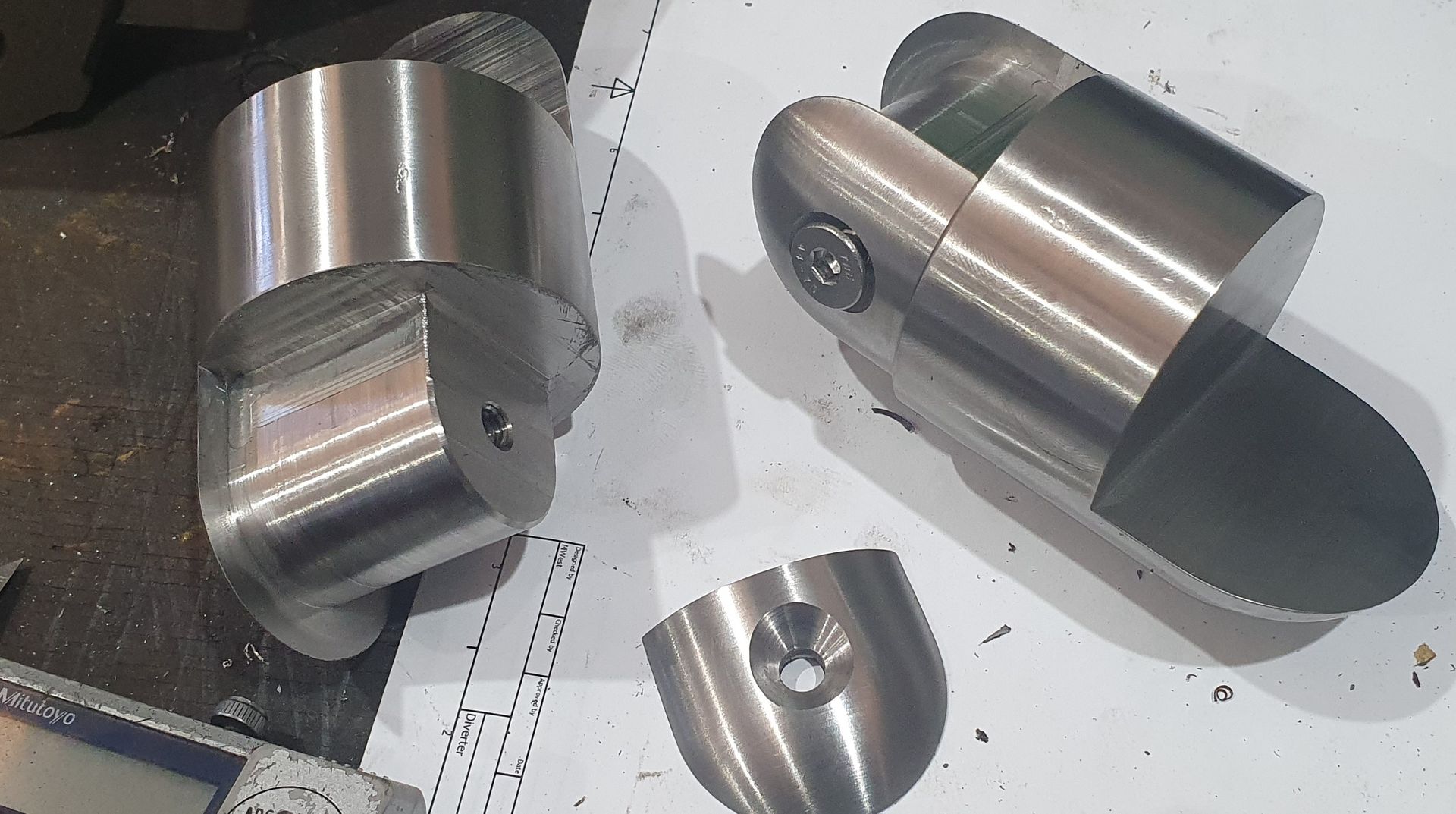 Two pieces of metal are sitting on top of a table.