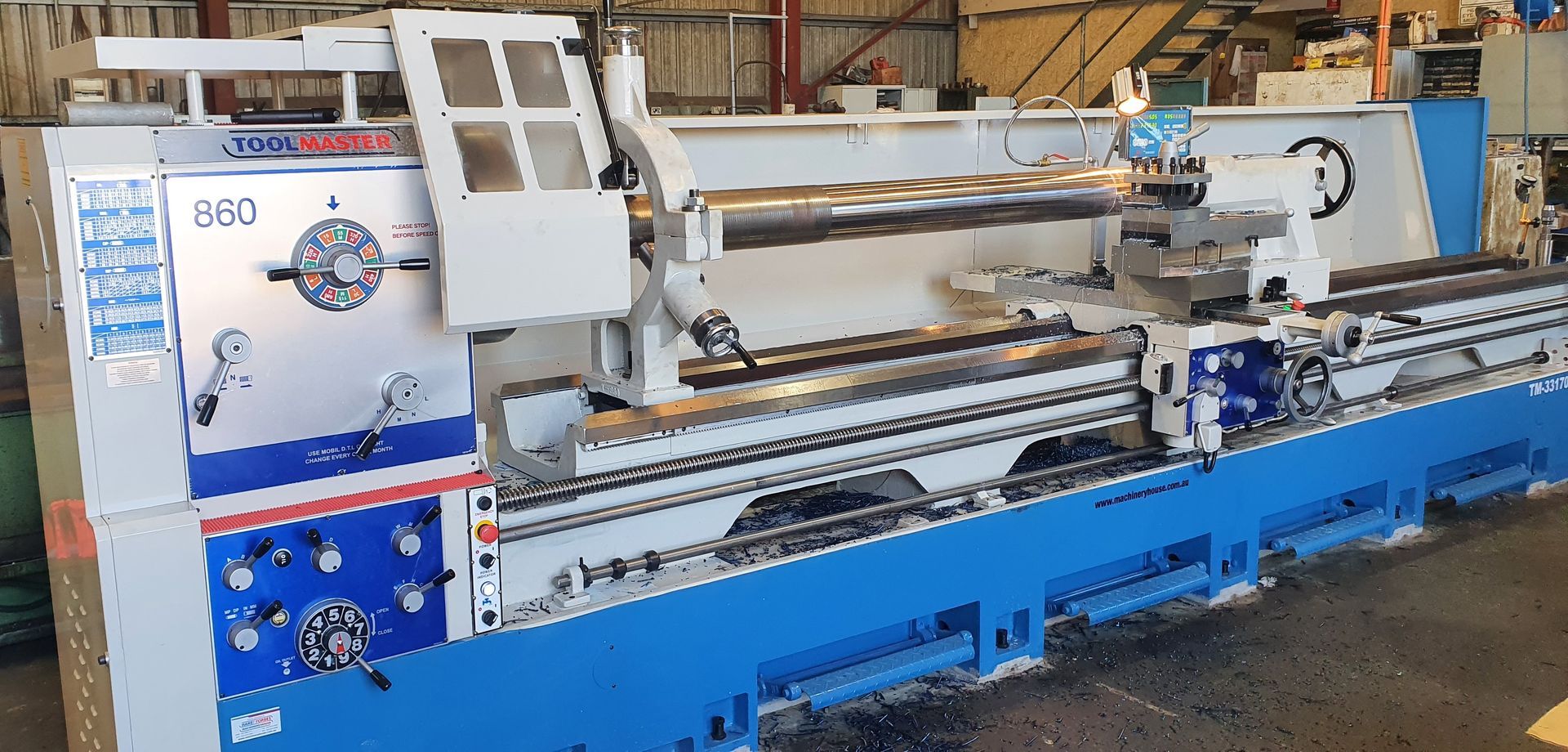 A large lathe is sitting in a warehouse.