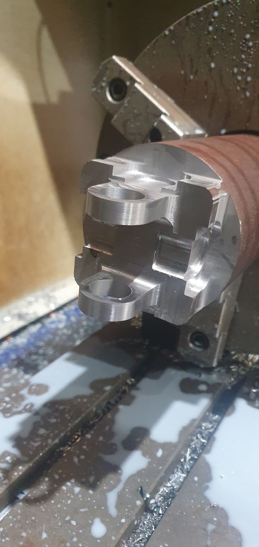 A machine is cutting a piece of metal on a table.
