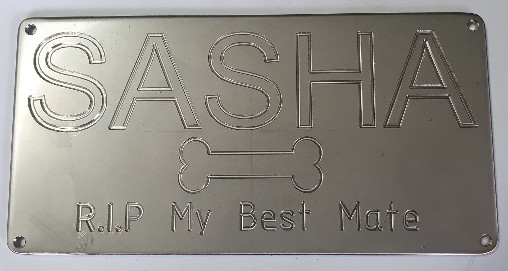 A metal sign that says sasha rip my best mate
