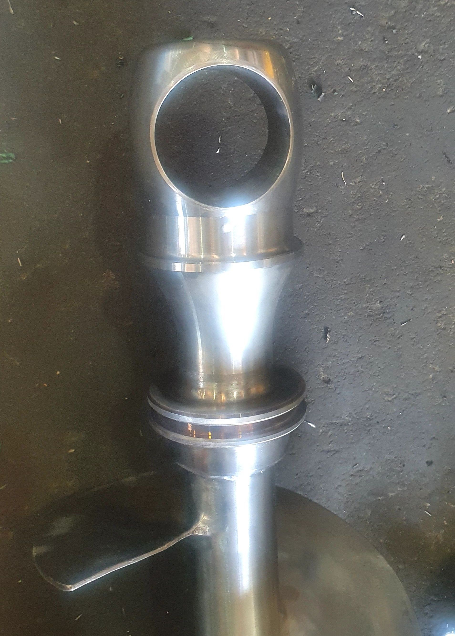 A close up of a metal object with a hole in the middle.