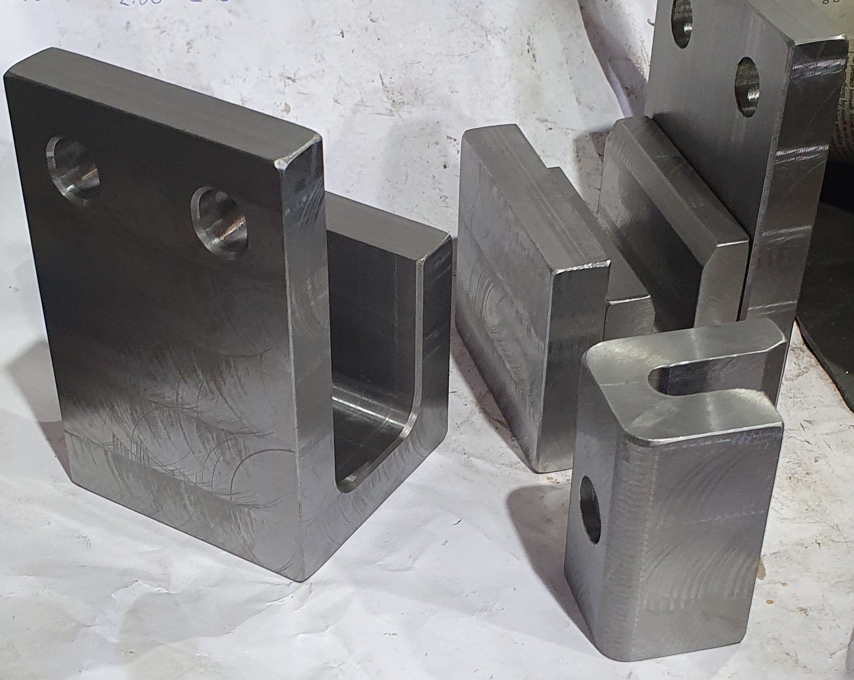 A bunch of metal pieces are sitting on top of each other on a table.