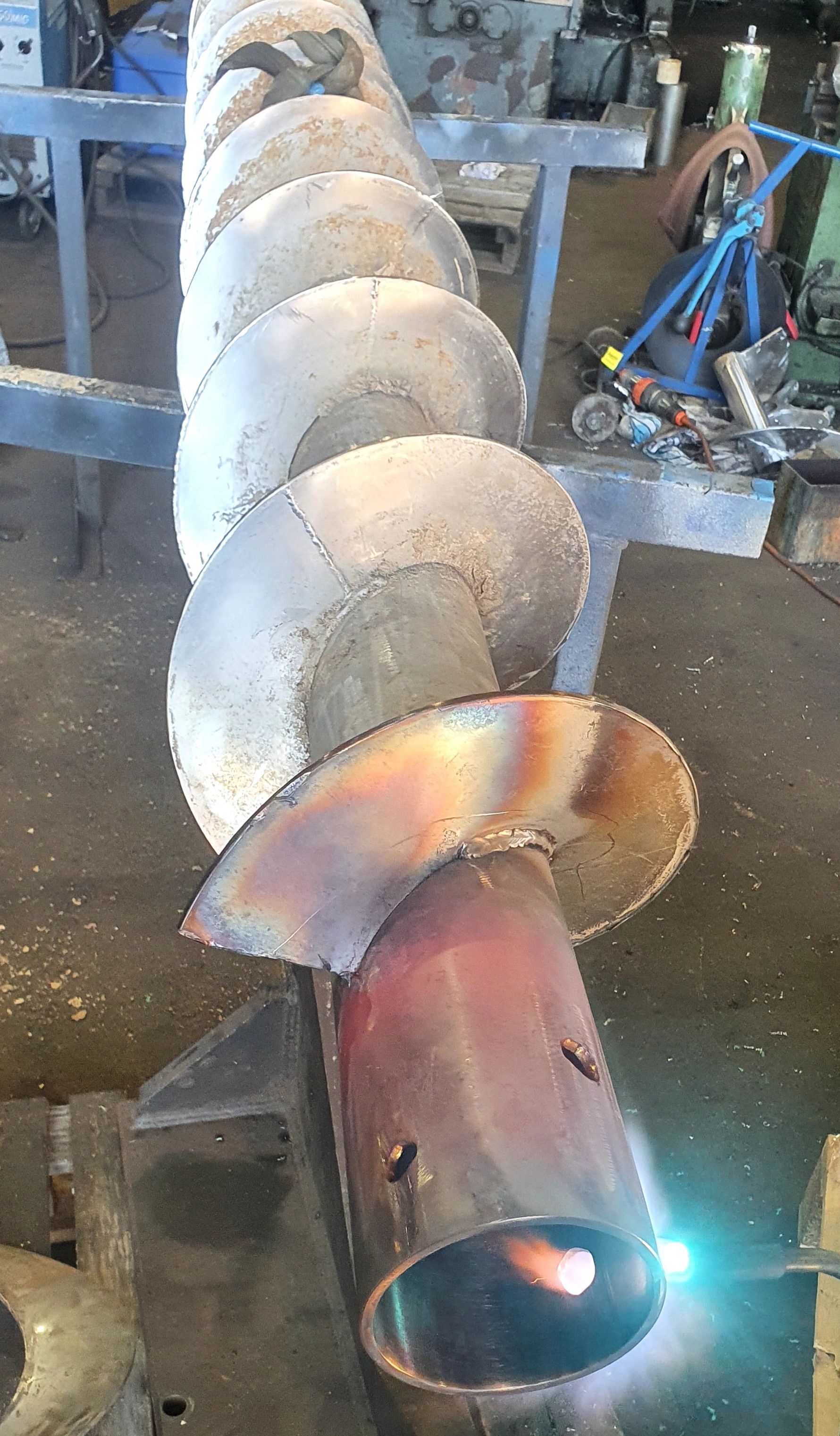 A close up of a metal pipe with a flame coming out of it.