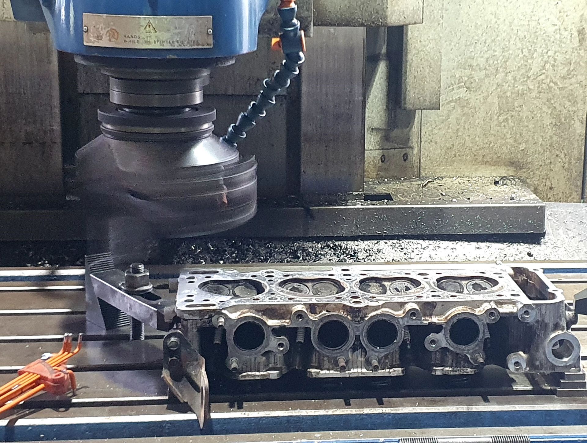 A machine is cutting a piece of metal on a table